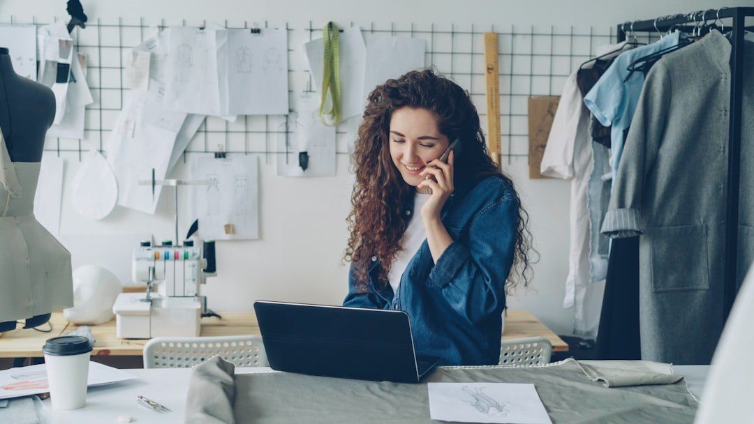 Selbstständige bei der Arbeit mit Laptop und Smartphone.